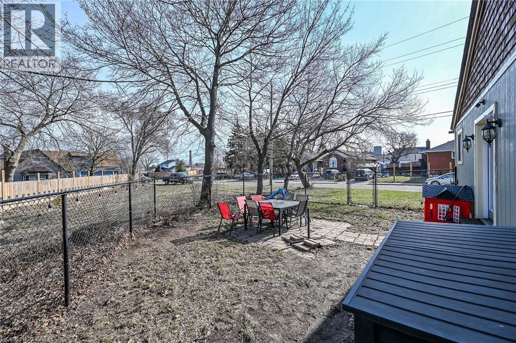 Fenced backyard featuring a patio area, a residential view, and outdoor dining area - 703 Dunn Avenue, Hamilton, ON - Outdoor