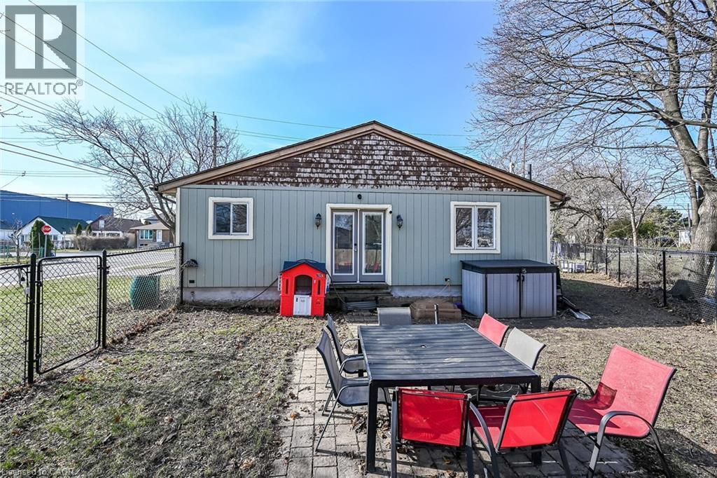 Back of property with a fenced backyard, a gate, french doors, outdoor dining space, and a patio area - 703 Dunn Avenue, Hamilton, ON - Outdoor