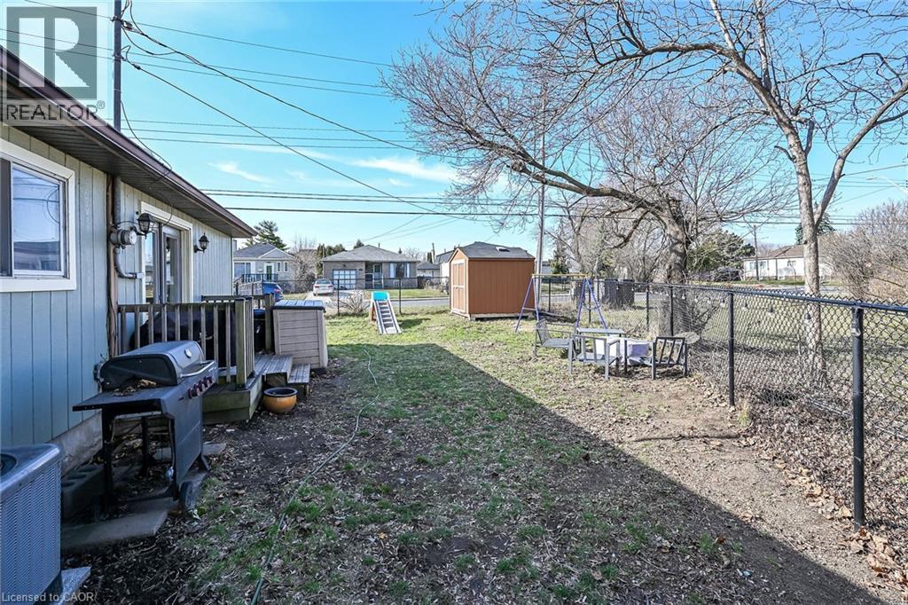 Fenced backyard featuring a shed and a residential view - 703 Dunn Avenue, Hamilton, ON - Outdoor