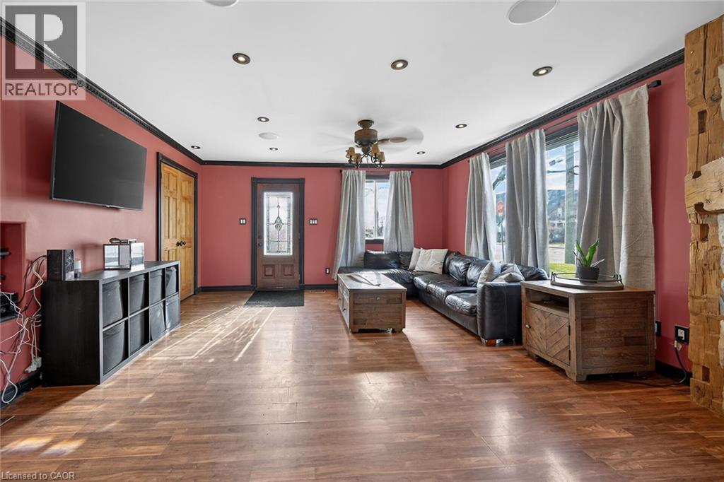 Living area with ceiling fan, dark wood-style floors, ornamental molding, and recessed lighting - 703 Dunn Avenue, Hamilton, ON - Indoor