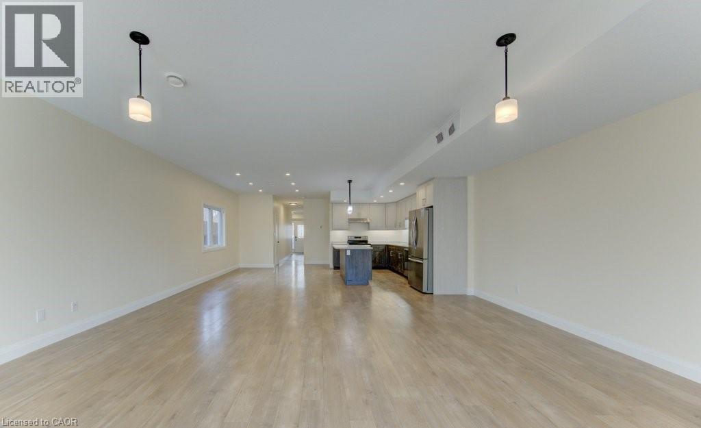 Unfurnished living room featuring light wood-type flooring and recessed lighting - 113 Walter Street, Kitchener, ON - Indoor Photo Showing Other Room