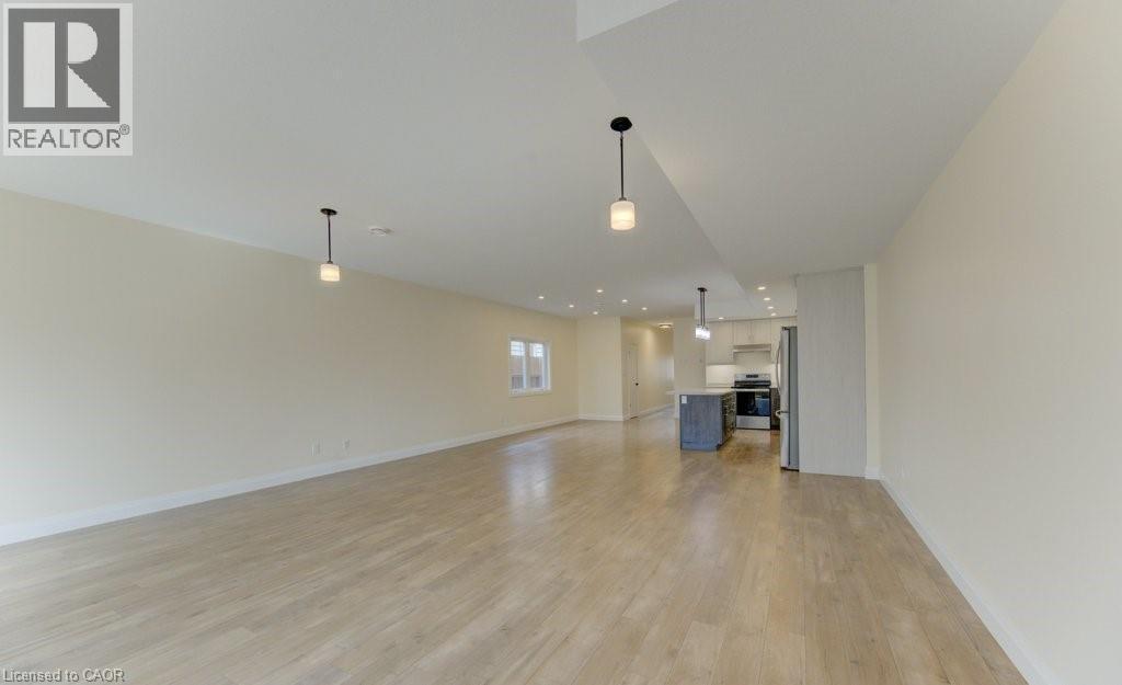 Unfurnished living room featuring light wood-style flooring and recessed lighting - 113 Walter Street, Kitchener, ON - Indoor Photo Showing Other Room