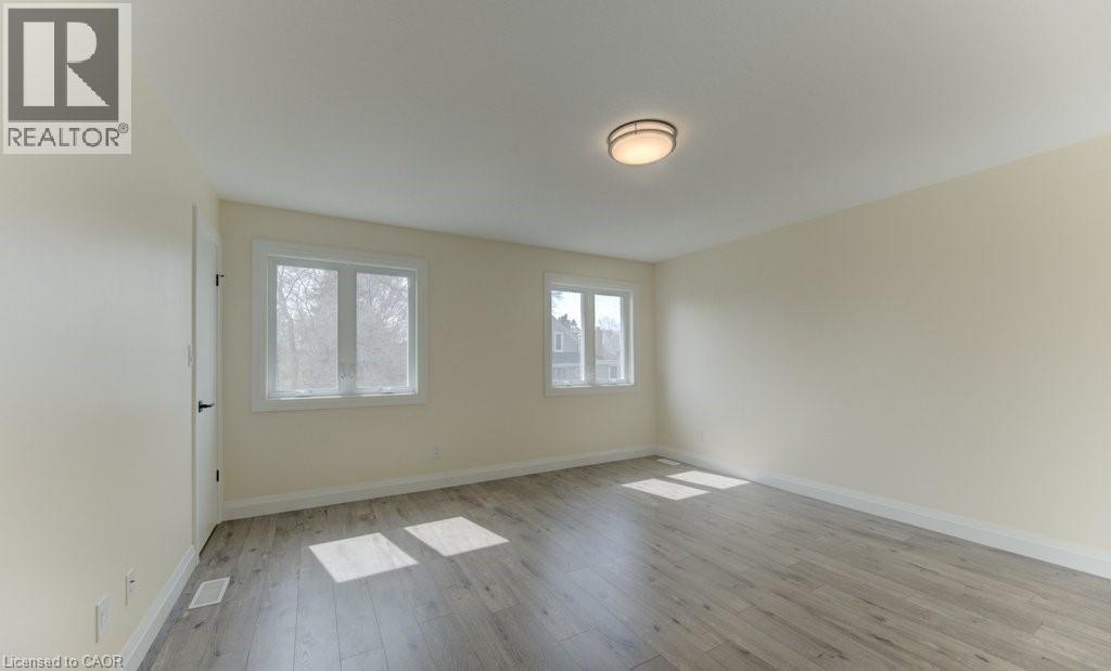 Unfurnished room featuring baseboards and light wood finished floors - 113 Walter Street, Kitchener, ON - Indoor Photo Showing Other Room