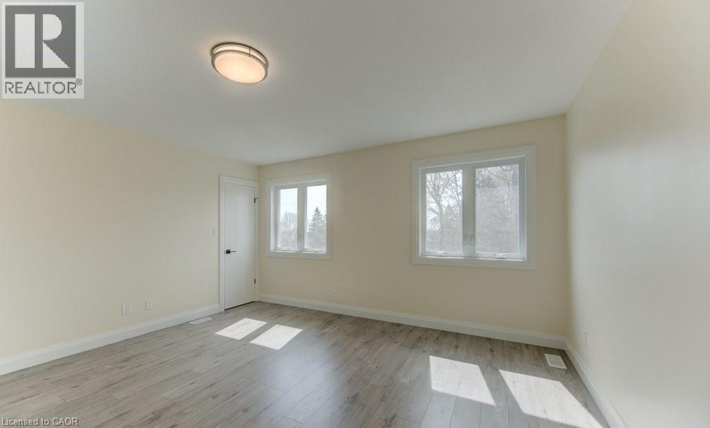 Unfurnished room with baseboards and light wood-style floors - 113 Walter Street, Kitchener, ON - Indoor Photo Showing Other Room