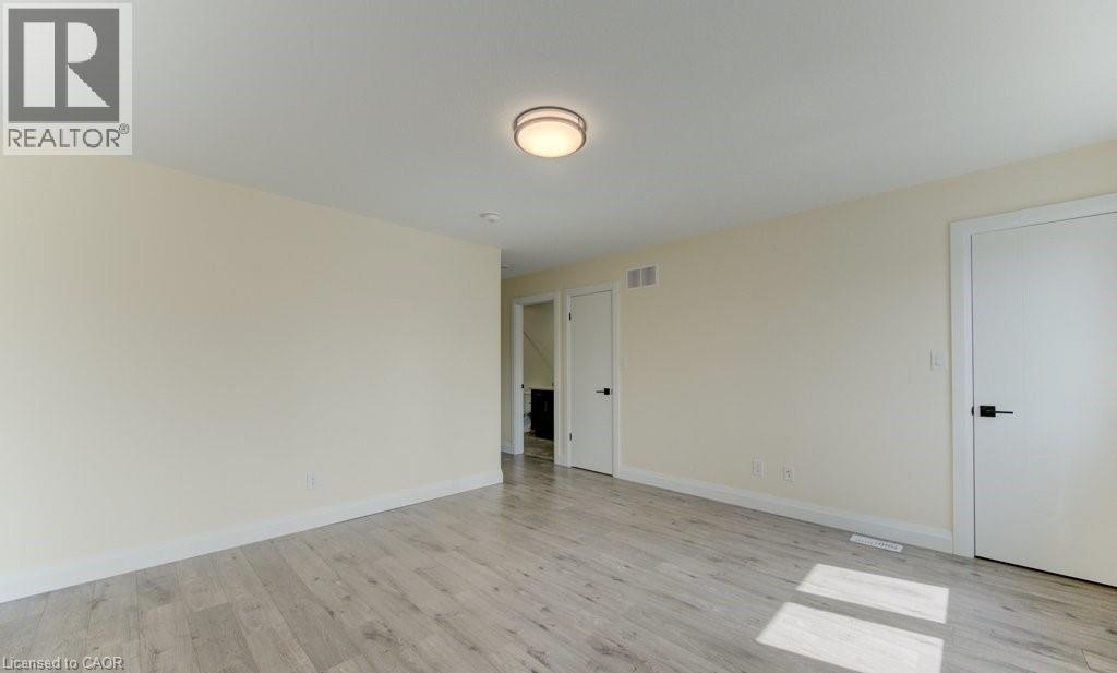 Spare room featuring light wood-style floors and baseboards - 113 Walter Street, Kitchener, ON - Indoor Photo Showing Other Room