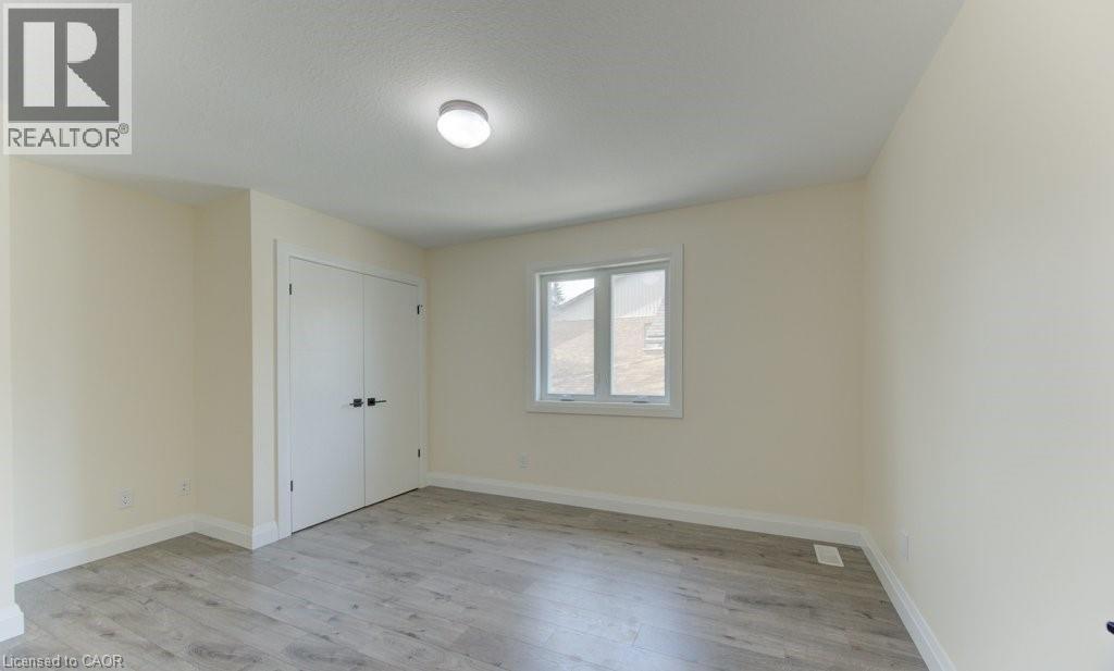 Unfurnished bedroom featuring light wood-style floors and a closet - 113 Walter Street, Kitchener, ON - Indoor Photo Showing Other Room