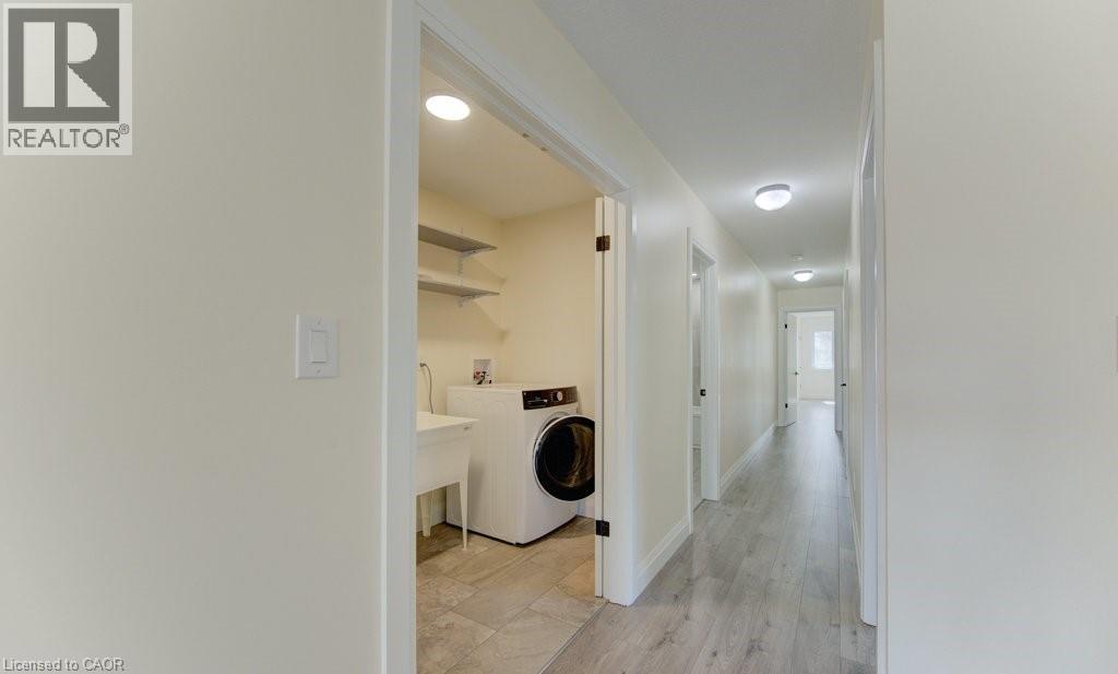 Laundry area with washer / clothes dryer and light wood-style flooring - 113 Walter Street, Kitchener, ON - Indoor Photo Showing Laundry Room