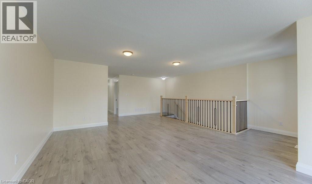 Empty room with light wood-style flooring and baseboards - 113 Walter Street, Kitchener, ON - Indoor Photo Showing Other Room