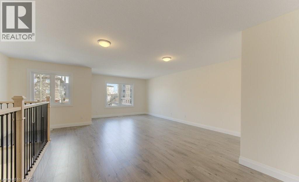 Unfurnished room featuring baseboards and light wood-style flooring - 113 Walter Street, Kitchener, ON - Indoor Photo Showing Other Room