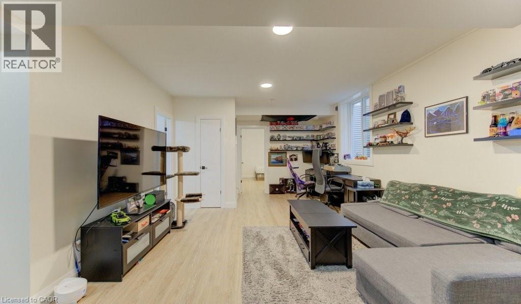 Living room with light wood-type flooring, a desk, and recessed lighting - 113 Walter Street, Kitchener, ON - Indoor