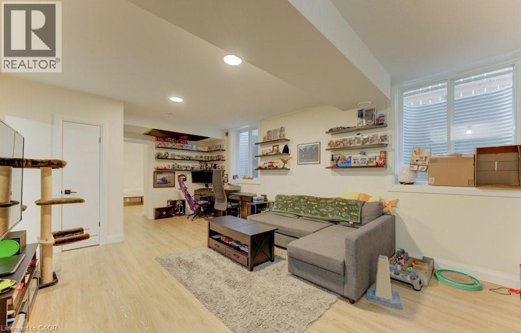 Living room featuring light wood-type flooring, an office area, and recessed lighting - 113 Walter Street, Kitchener, ON - Indoor