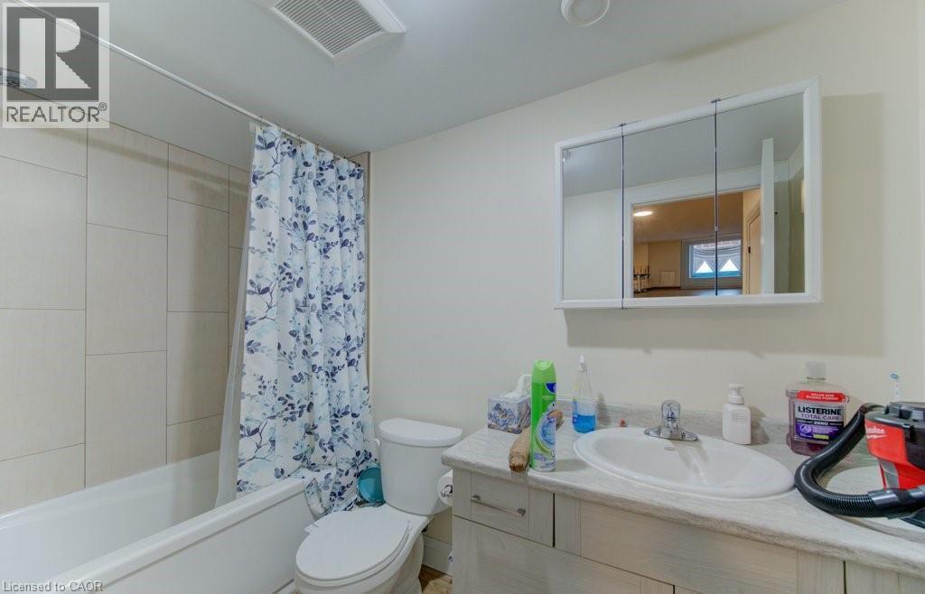 Bathroom featuring vanity and shower / bath combo with shower curtain - 113 Walter Street, Kitchener, ON - Indoor Photo Showing Bathroom