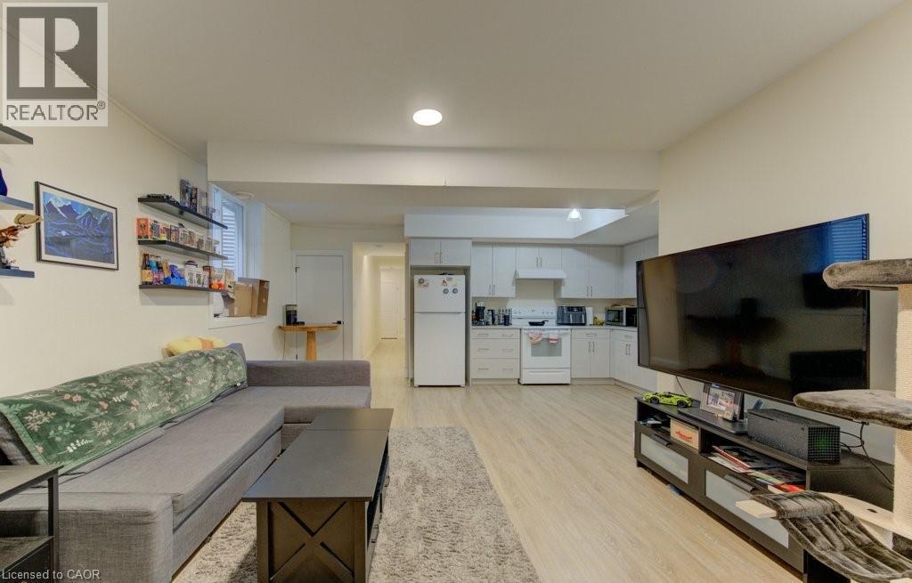 Living area featuring light wood finished floors and recessed lighting - 113 Walter Street, Kitchener, ON - Indoor