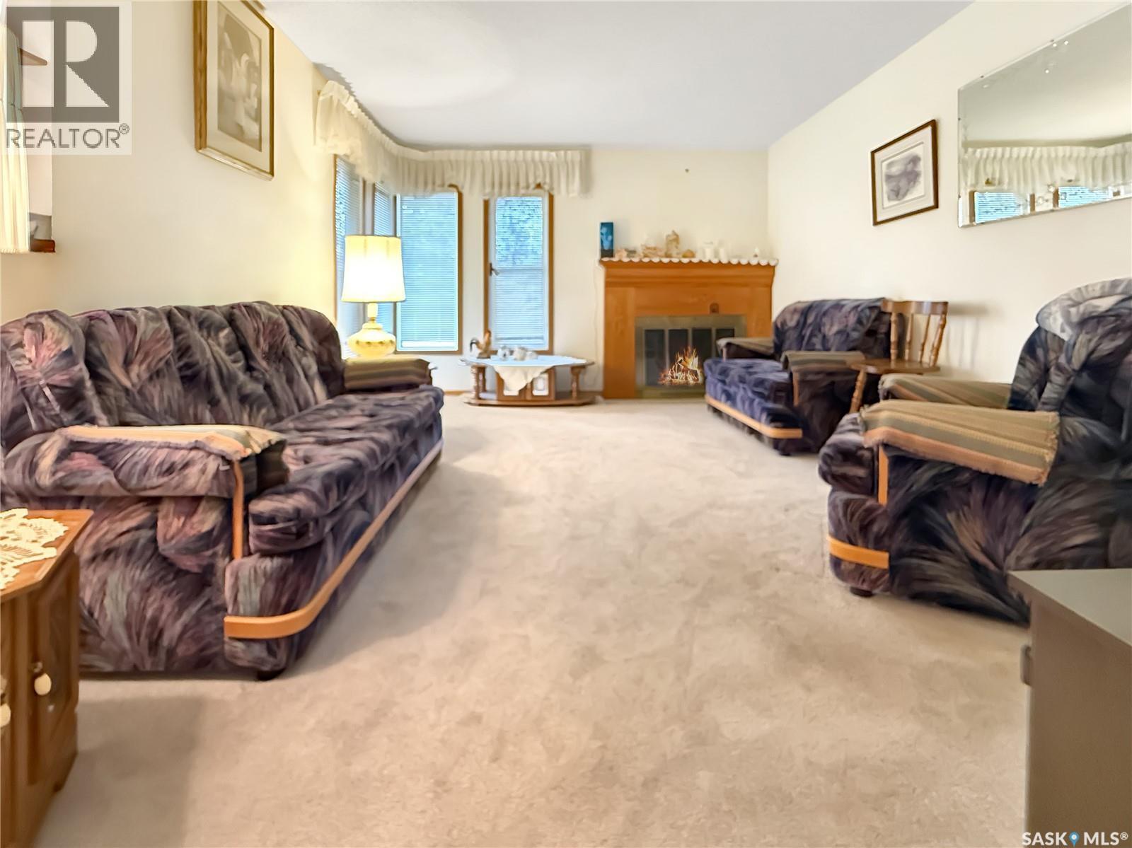 880 3Rd Avenue Ne, Swift Current, SK - Indoor Photo Showing Living Room With Fireplace