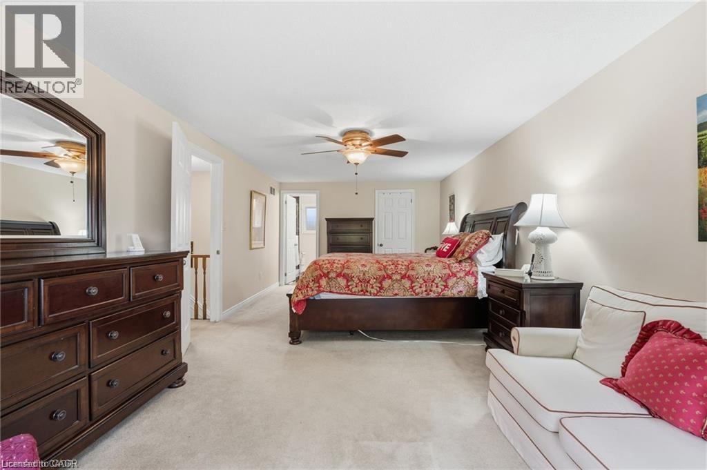 Bedroom with light carpet and ceiling fan - 668 Tomahawk Crescent, Ancaster, ON - Indoor Photo Showing Bedroom