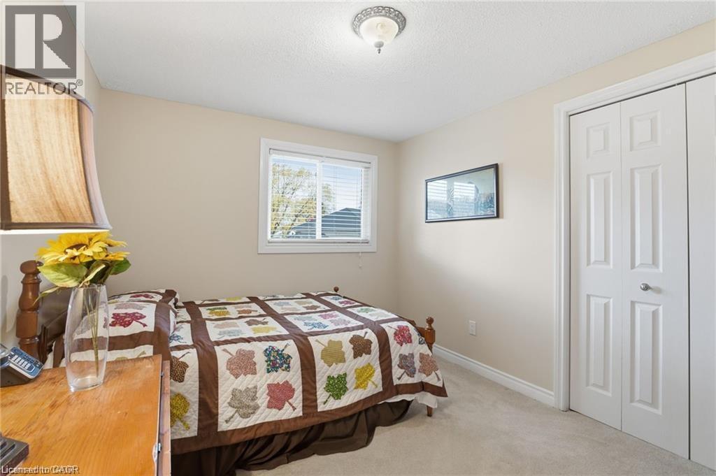 Bedroom featuring light colored carpet and a closet - 668 Tomahawk Crescent, Ancaster, ON - Indoor Photo Showing Bedroom