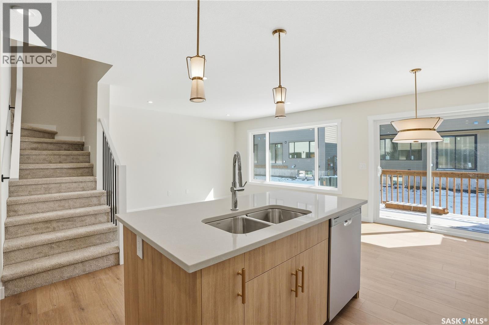 404 155 Mcfaull Way, Saskatoon, SK - Indoor Photo Showing Kitchen With Double Sink