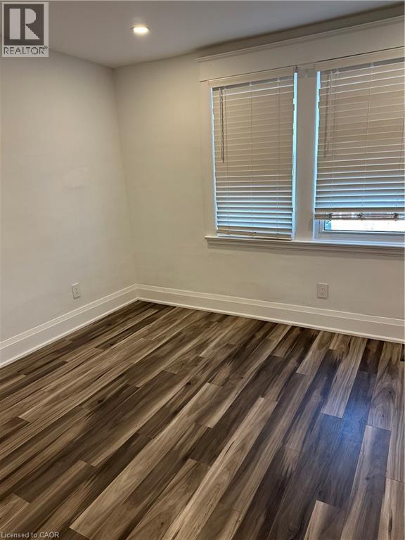 Unfurnished room with dark hardwood / wood-style floors - 1090 Cannon Street E, Hamilton, ON - Indoor Photo Showing Other Room