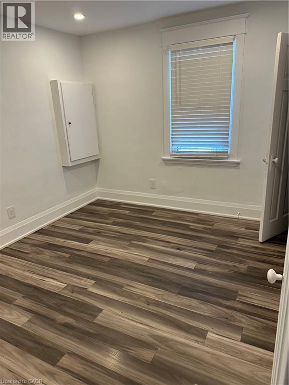 Unfurnished room with dark hardwood / wood-style flooring - 1090 Cannon Street E, Hamilton, ON - Indoor Photo Showing Other Room