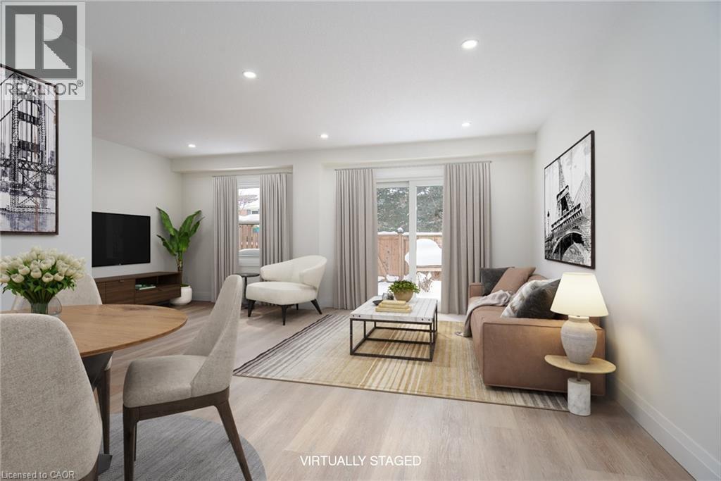 Living room with light wood-style floors, healthy amount of natural light, and recessed lighting - 27 Queenston Drive, Kitchener, ON - Indoor