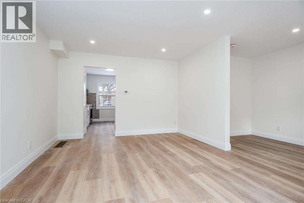 Spare room featuring light wood finished floors and recessed lighting - 27 Queenston Drive, Kitchener, ON - Indoor Photo Showing Other Room