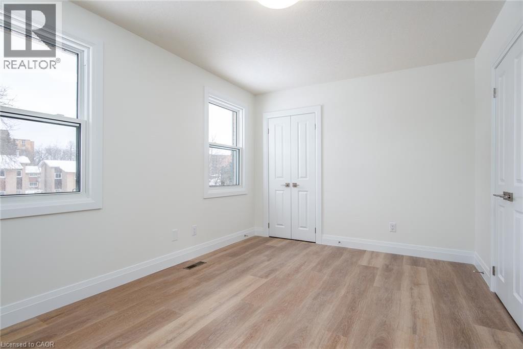 Unfurnished bedroom featuring light wood-type flooring and a closet - 27 Queenston Drive, Kitchener, ON - Indoor Photo Showing Other Room