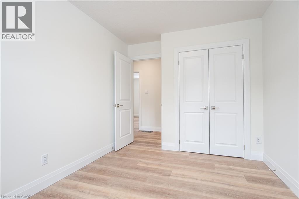 Unfurnished bedroom with light wood-style floors and a closet - 27 Queenston Drive, Kitchener, ON - Indoor Photo Showing Other Room