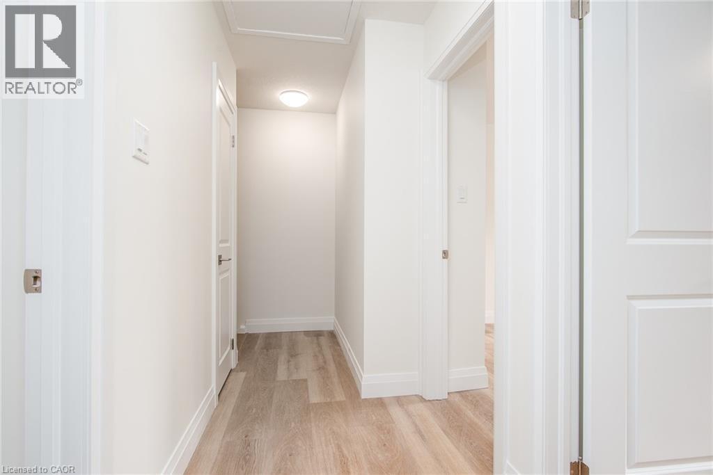 Hallway with light wood-style floors and baseboards - 27 Queenston Drive, Kitchener, ON - Indoor Photo Showing Other Room