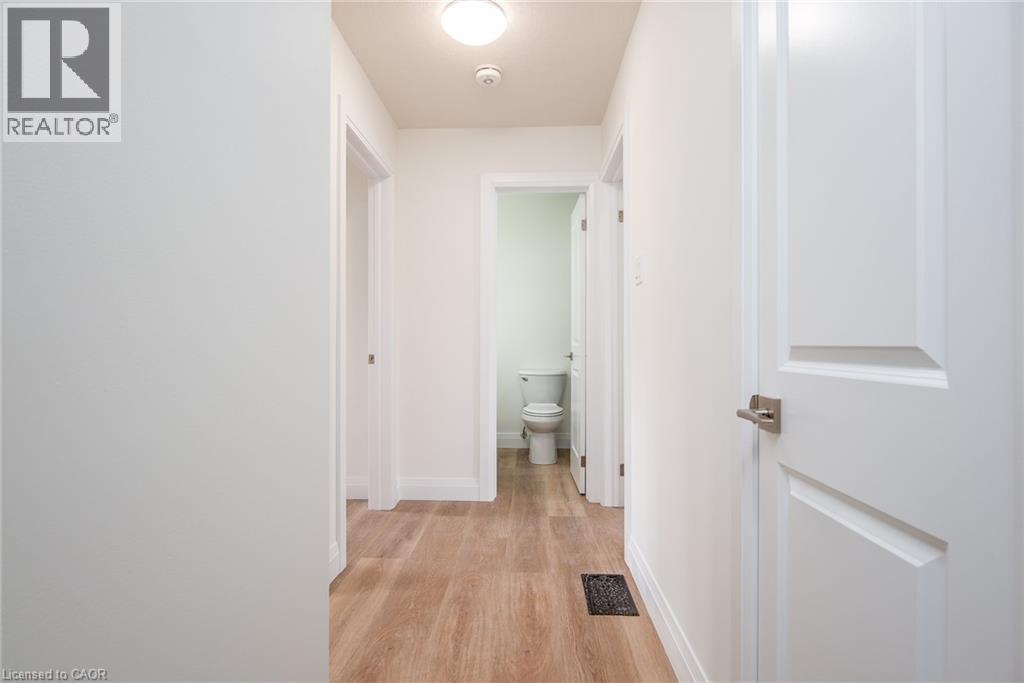 Corridor with baseboards and light wood-type flooring - 27 Queenston Drive, Kitchener, ON - Indoor Photo Showing Other Room