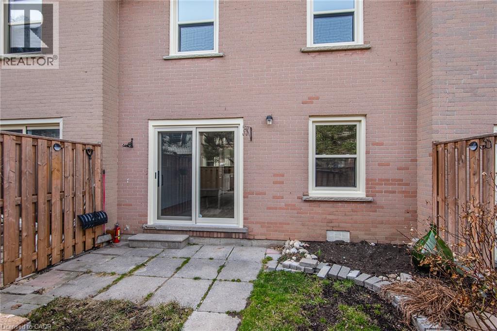 Rear view of house featuring brick siding and a patio - 27 Queenston Drive, Kitchener, ON - Outdoor With Exterior