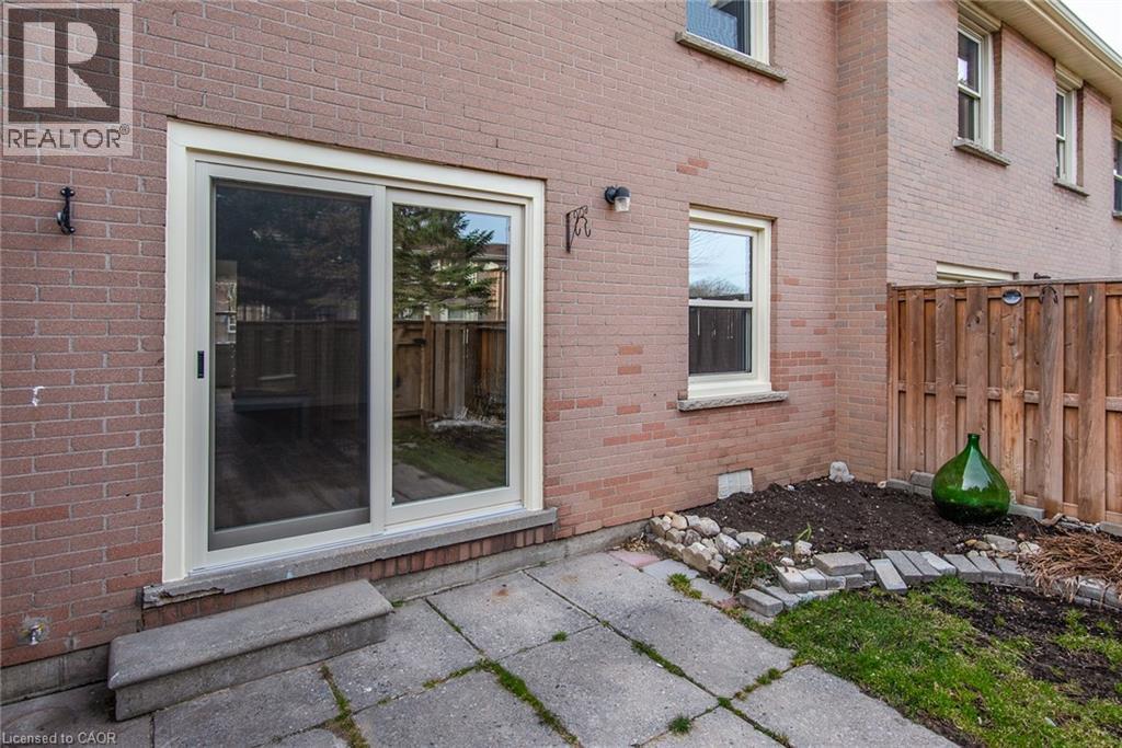 Doorway to property featuring brick siding and a patio - 27 Queenston Drive, Kitchener, ON - Outdoor With Exterior