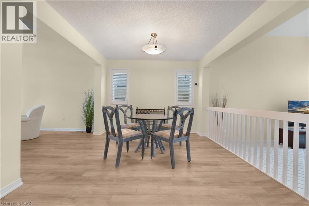 Dining space with light wood-style flooring and a textured ceiling - 90 Westlawn Drive, Hamilton, ON - Indoor Photo Showing Dining Room