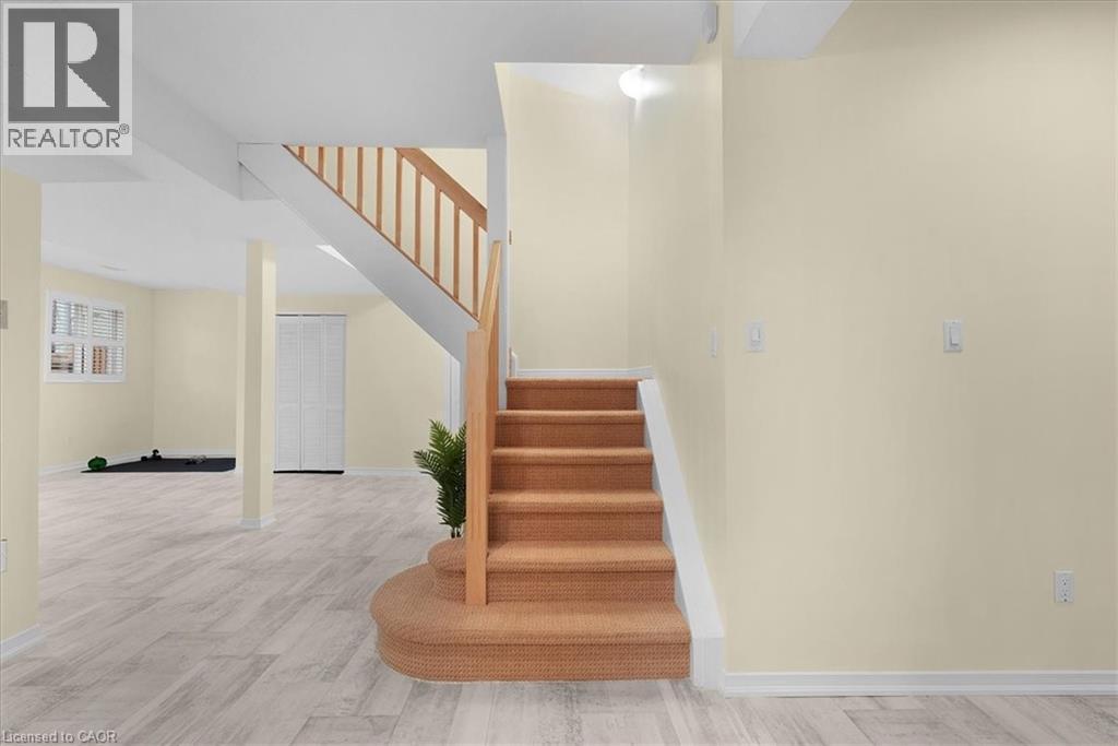 Stairway with baseboards and wood finished floors - 90 Westlawn Drive, Hamilton, ON - Indoor Photo Showing Other Room