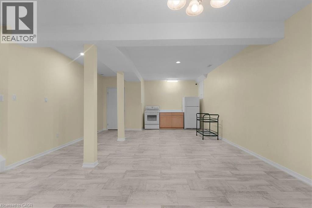 Finished below grade area featuring freestanding refrigerator and recessed lighting - 90 Westlawn Drive, Hamilton, ON - Indoor Photo Showing Other Room