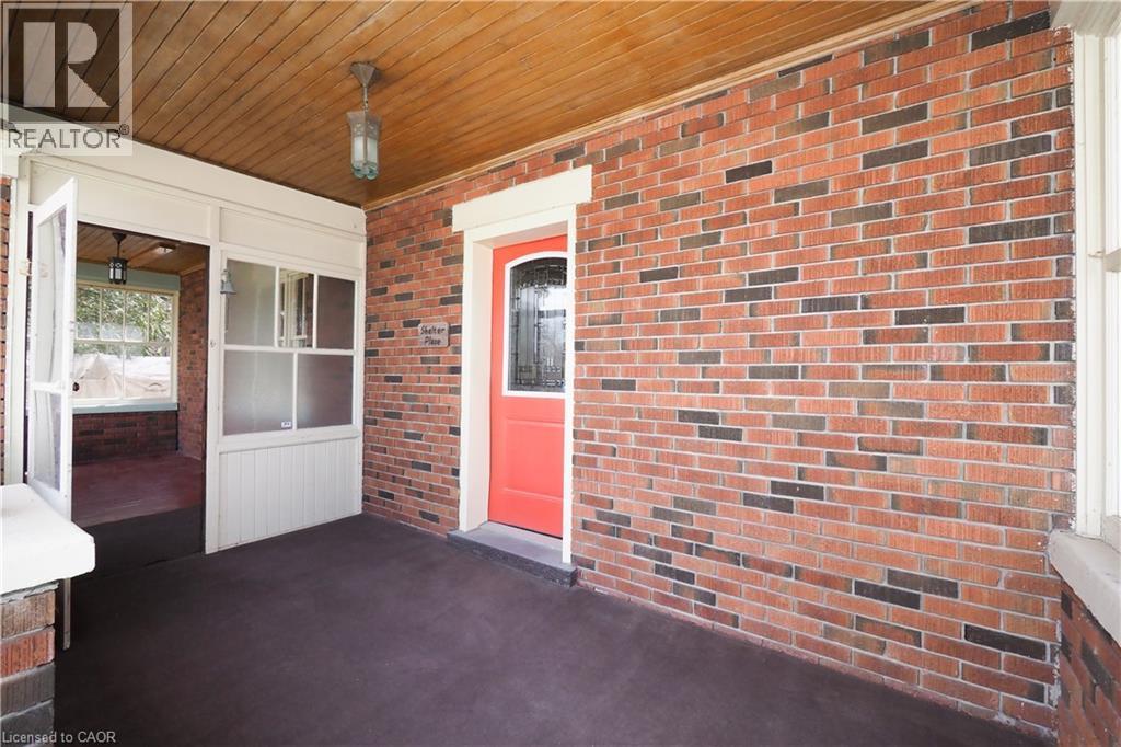 Front doors to enclosed porch/sunroom and front foyer - 33 Main Street E, Drayton, ON - Outdoor With Exterior