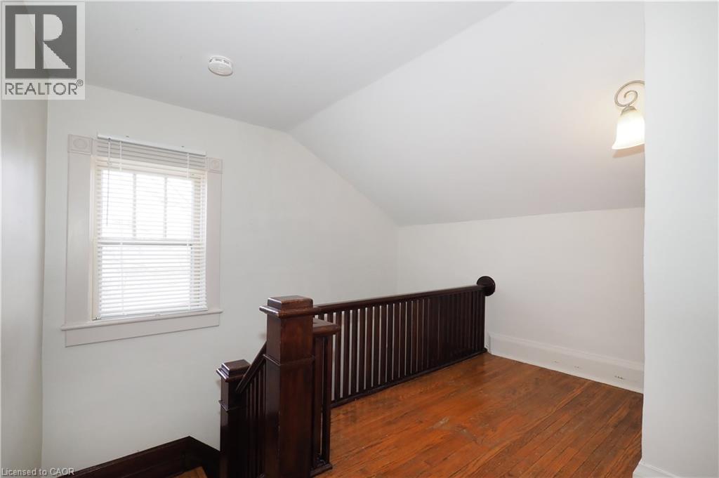 Stairway featuring classic wood railing and wood floors - 33 Main Street E, Drayton, ON - Indoor Photo Showing Other Room