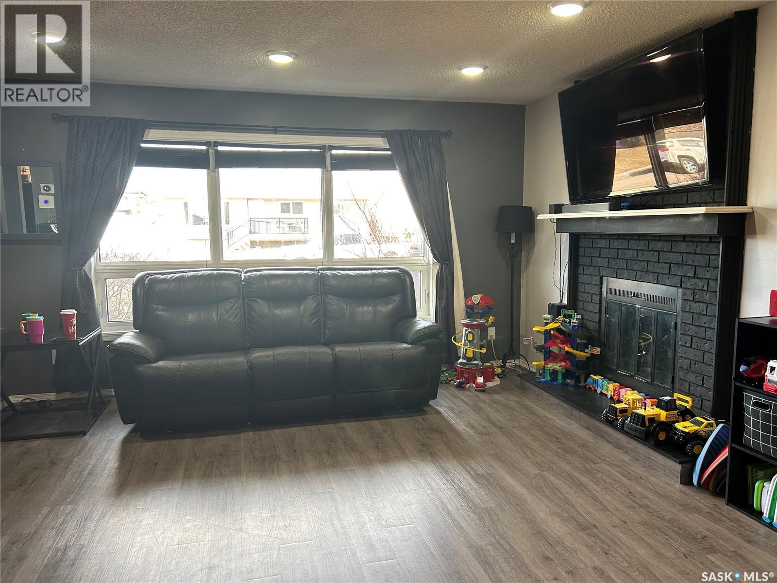 488 Willow Bay, Estevan, SK - Indoor Photo Showing Living Room With Fireplace