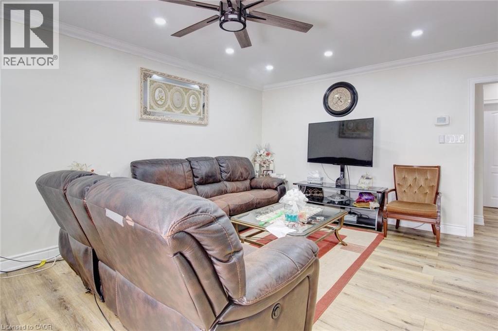 Living area featuring crown molding, a ceiling fan, light wood-type flooring, and recessed lighting - 823 Queensdale Avenue E, Hamilton, ON - Indoor Photo Showing Living Room