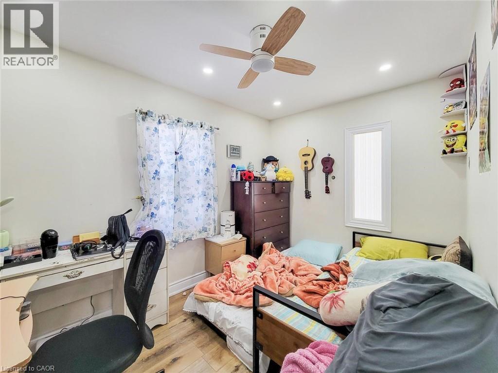 Bedroom featuring hardwood / wood-style floors, an office area, recessed lighting, and ceiling fan - 823 Queensdale Avenue E, Hamilton, ON - Indoor Photo Showing Bedroom