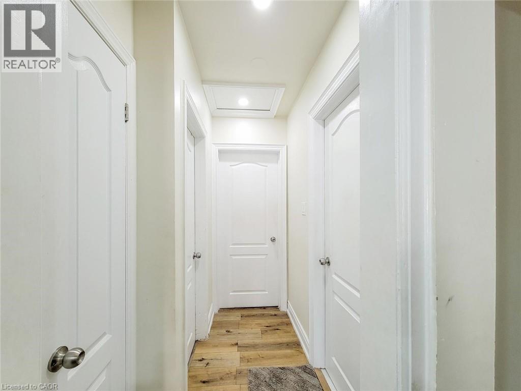 Hallway with wood-finish flooring, white walls, and recessed lighting - 823 Queensdale Avenue E, Hamilton, ON - Indoor Photo Showing Other Room