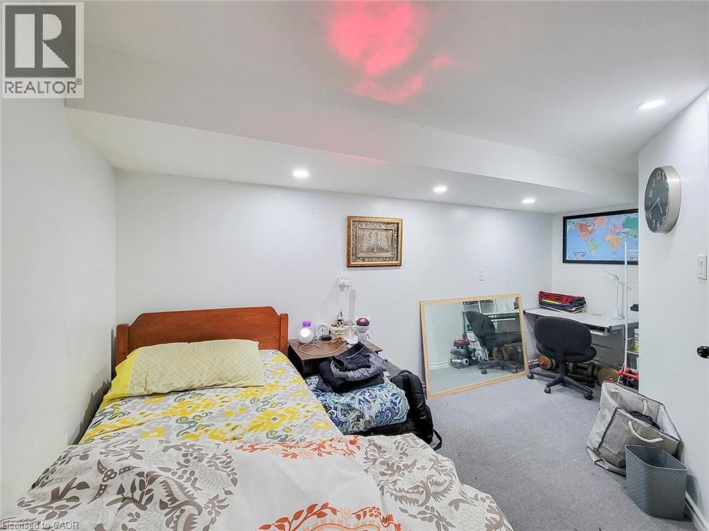 Recessed ceiling lighting illuminates the room with gray carpeting and white walls - 823 Queensdale Avenue E, Hamilton, ON - Indoor Photo Showing Bedroom