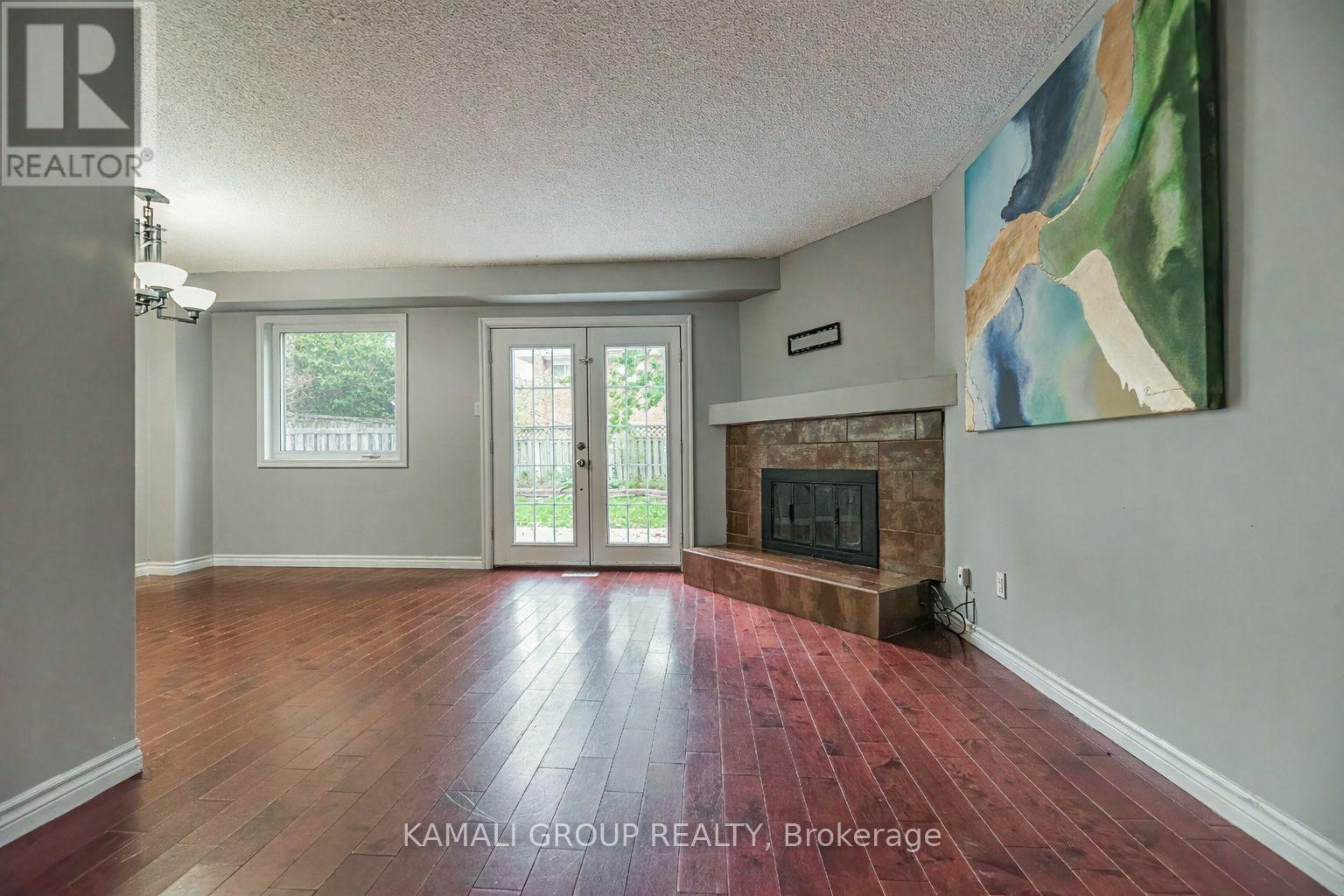 Walkout to Patio & Large Yard - Main - 77 Ecclestone Drive, Brampton, ON - Indoor Photo Showing Living Room With Fireplace