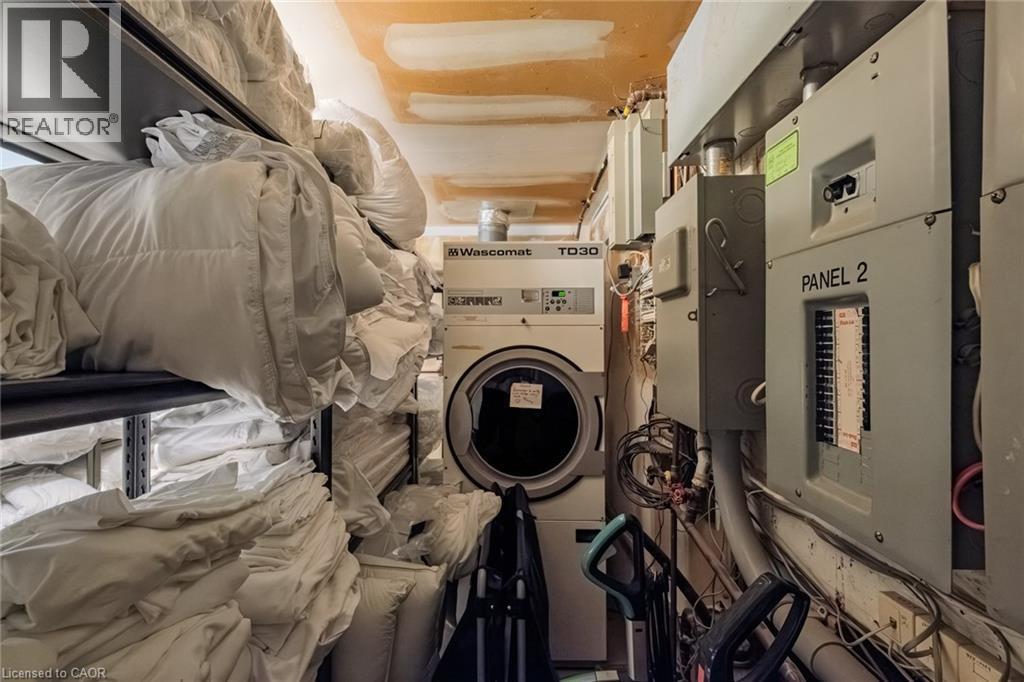 Laundry area with washer / clothes dryer and electric panel - 30 John Street, Port Dover, ON