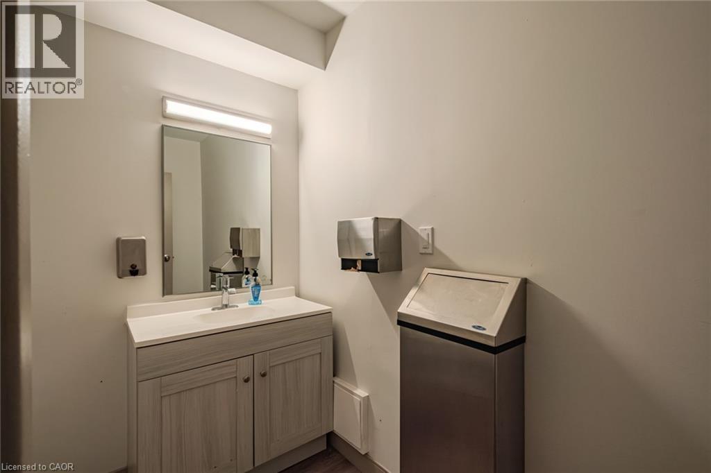 Bathroom featuring vanity and dark wood-style flooring - 30 John Street, Port Dover, ON