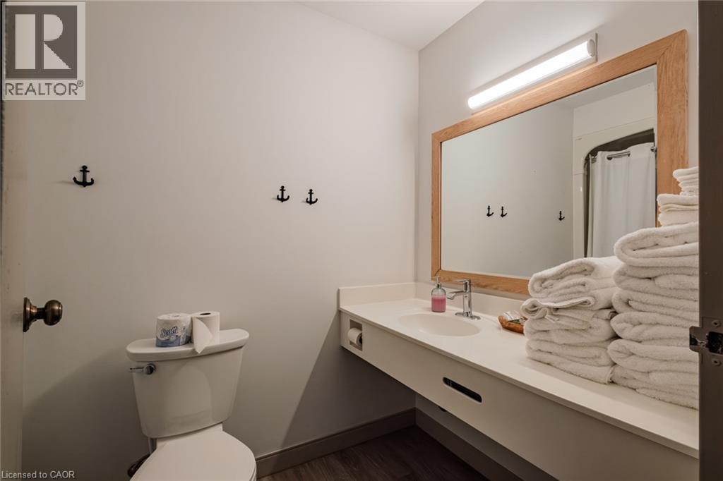 Bathroom with vanity, a shower with curtain, and dark wood-style flooring - 30 John Street, Port Dover, ON