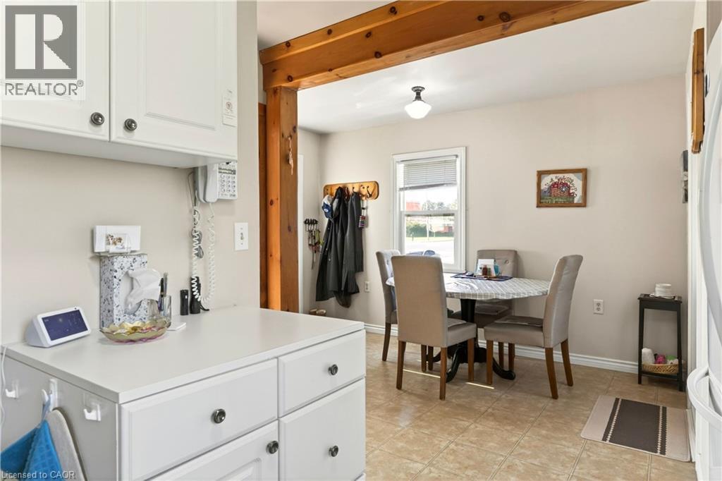 Kitchen featuring white cabinets, light countertops, and freestanding refrigerator - 944 Garth Street, Hamilton, ON - Indoor Photo Showing Dining Room