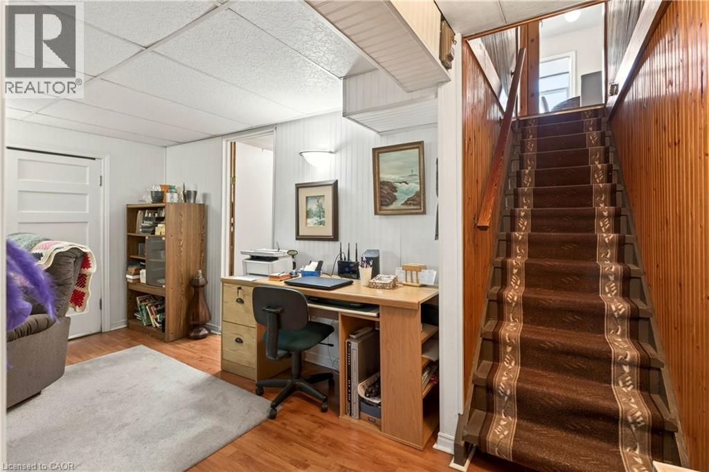 Office with light wood-style flooring, a drop ceiling, and wooden walls - 944 Garth Street, Hamilton, ON - Indoor Photo Showing Office
