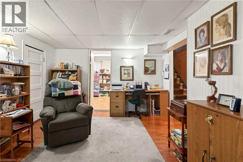 Office area featuring light wood-type flooring, a paneled ceiling, and wood walls - 944 Garth Street, Hamilton, ON - Indoor