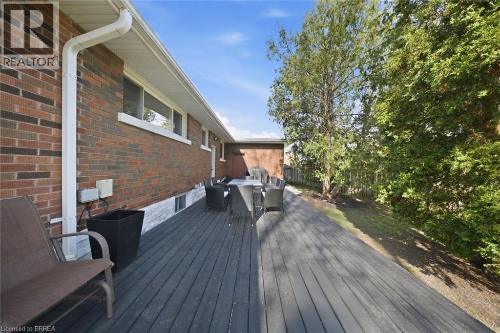 Expansive wood-finish deck with a red brick exterior - 71 Pinecrest Drive, Kitchener, ON - Outdoor With Deck Patio Veranda