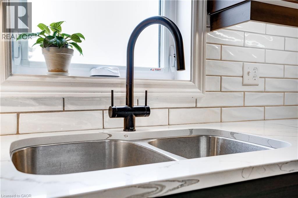 Kitchen view of light stone countertops - 23247 Beattie Line, Elgin, ON - Indoor Photo Showing Kitchen With Double Sink